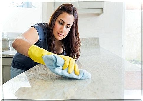 Young woman cleaning a tabletop