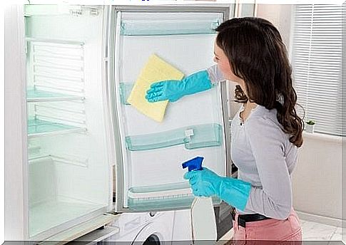 Woman cleaning refrigerator