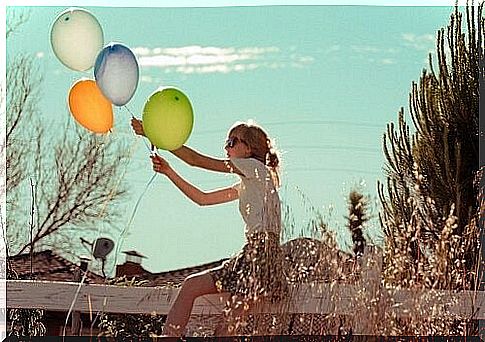 Young woman holding balloons