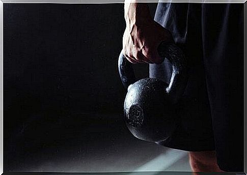 Man standing with a kettlebell