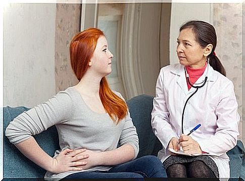 Woman at the doctor with stomach pain