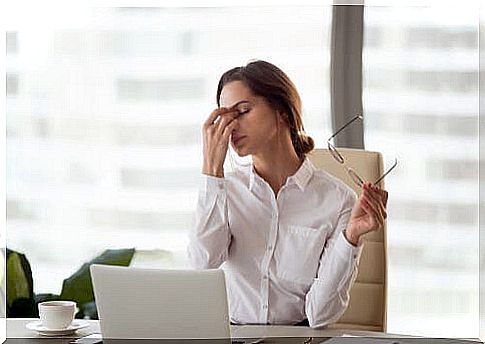 Woman at computer takes care of eyes