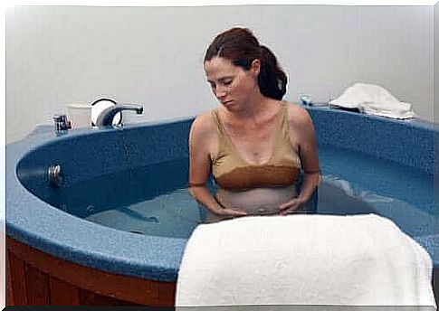 Woman in feeding vessel for water birth