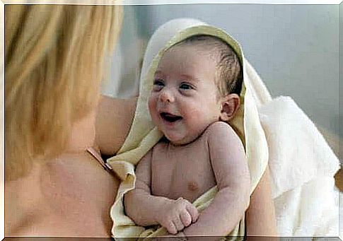 Mom with baby after bath getting ready to care for a baby's hair