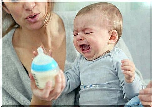 Baby with milk in front of her cries due to gastrointestinal infection in babies