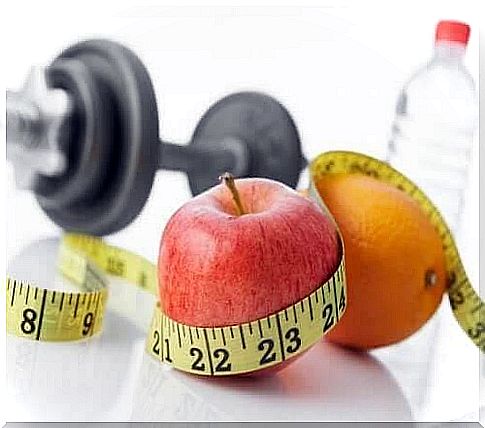 Fruit, water, measuring tape and dumbbell 