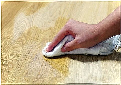 Cleaning wooden floors with tea towel