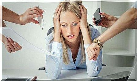 An overwhelmed woman tries to deal with stress