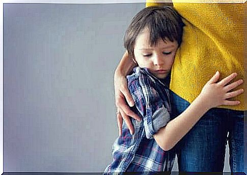 Boy hugging adult suffers from anxiety in children