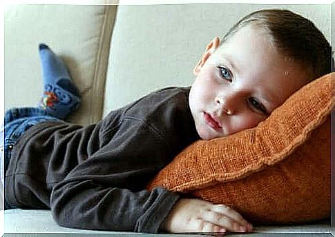 Boy lying on sofa