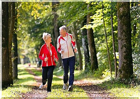 Older couple running in the woods