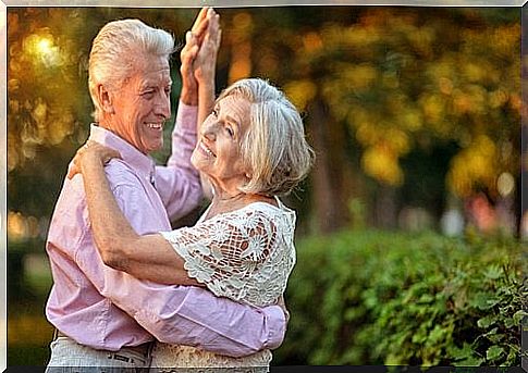 Older couple dancing outside - in shape after 50