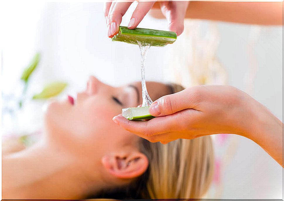 Woman lying down and another standing with aloe vera