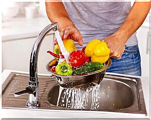 Person washes vegetables