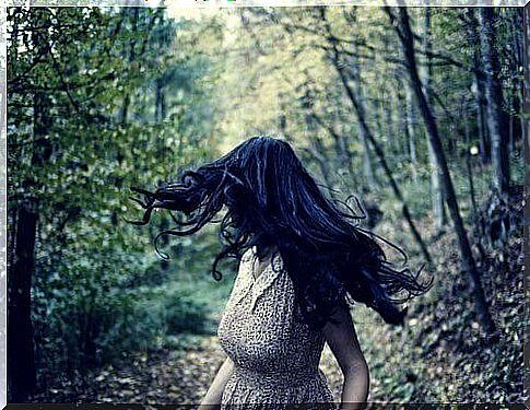 Woman walking in the woods