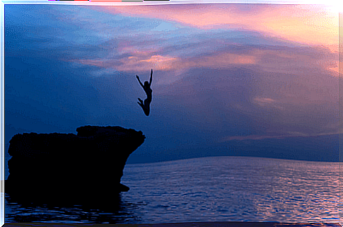 Woman jumping off a cliff - fearless life