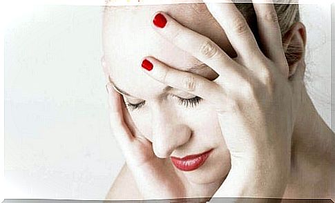 Woman with headache takes care of head